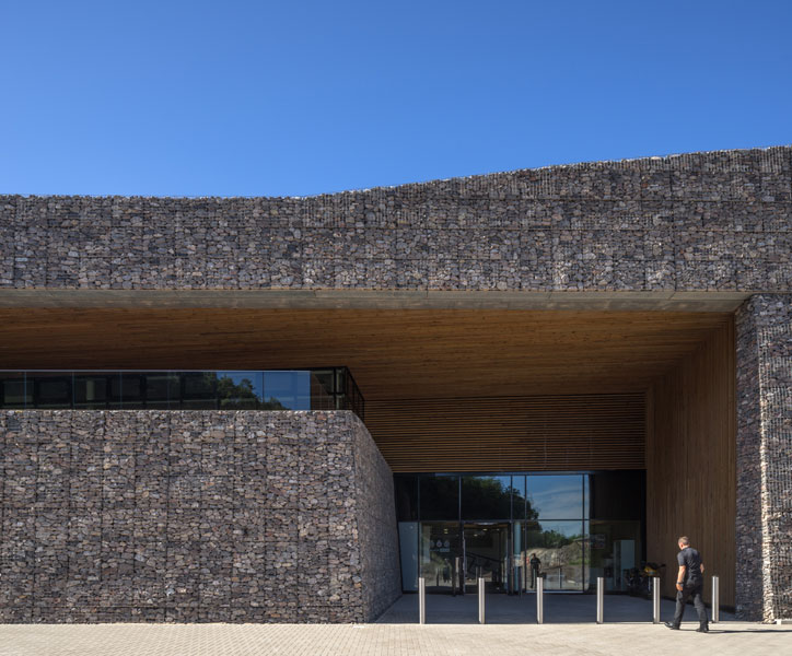 Entrance photograph with Gabion Wall and Timber soffit. 2 of 14.