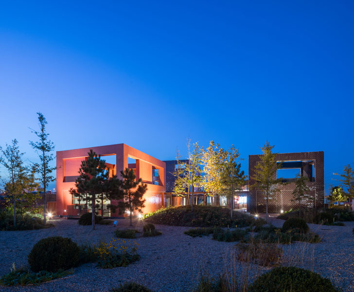 Shingle and planting illuminated against night sky. 10 of 11.