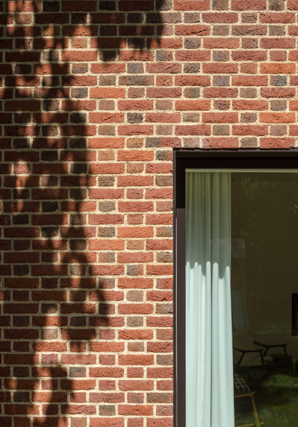 Detail photograph showing the slim window and brick cladding, 02 of 10