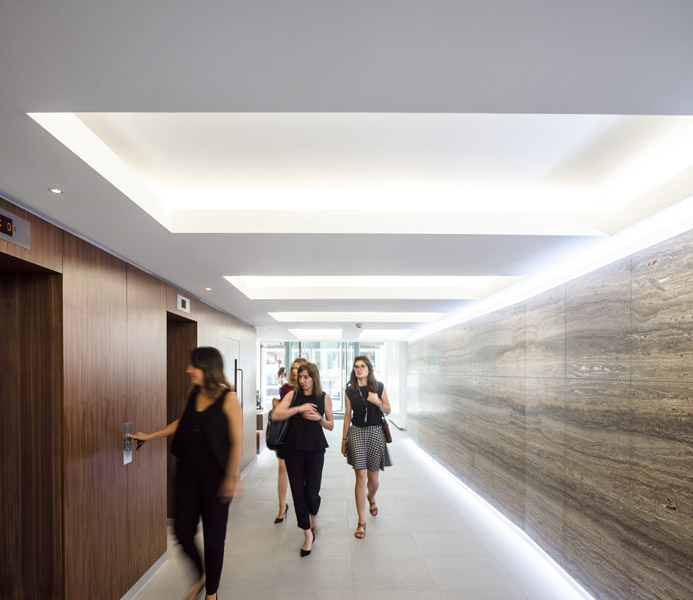 Internal lift lobby with stone clad wall and light shelves, 03 of 17