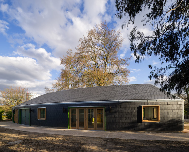 Exterior view showing slate clading and timber window frames, 08 of 16