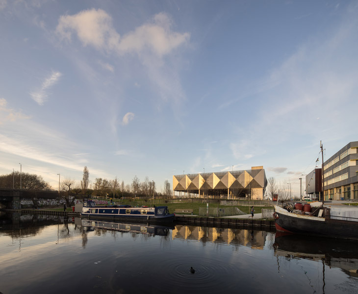 Sunset golden light reflects on the metal cladding in Stratford, London